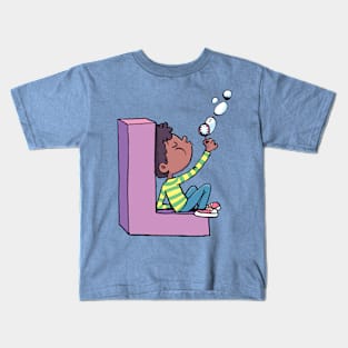 boy blows soap bubbles while sitting on the letter L Kids T-Shirt